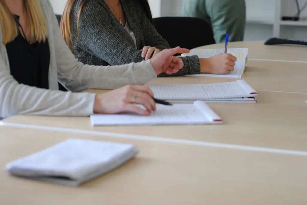 hands of students taking notes