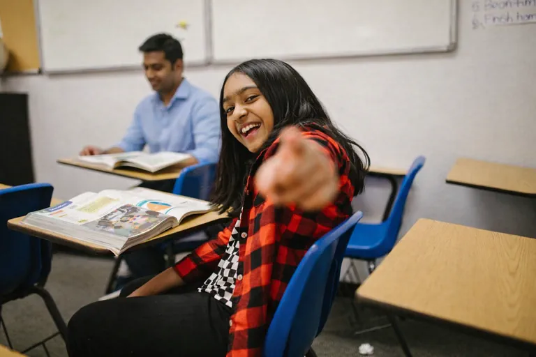 student pointing at camera